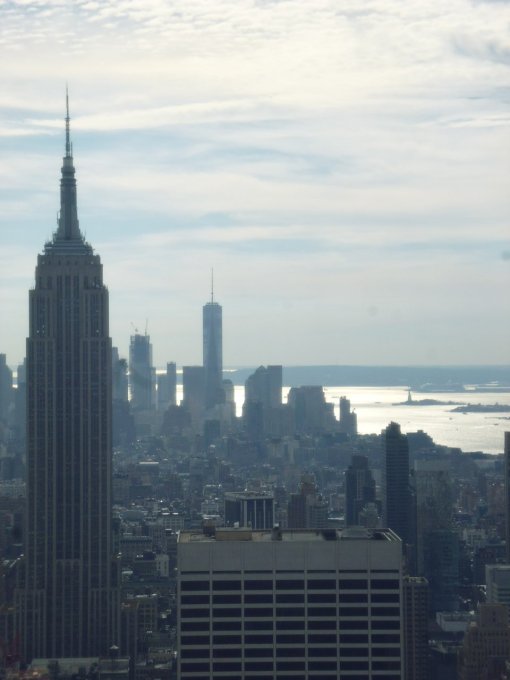 Empire State Building (foreground); Statue of Liberty (background)