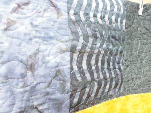 Above the topmost yellow strip, I quilted stylised suns, representing the harsh heat of an African summer