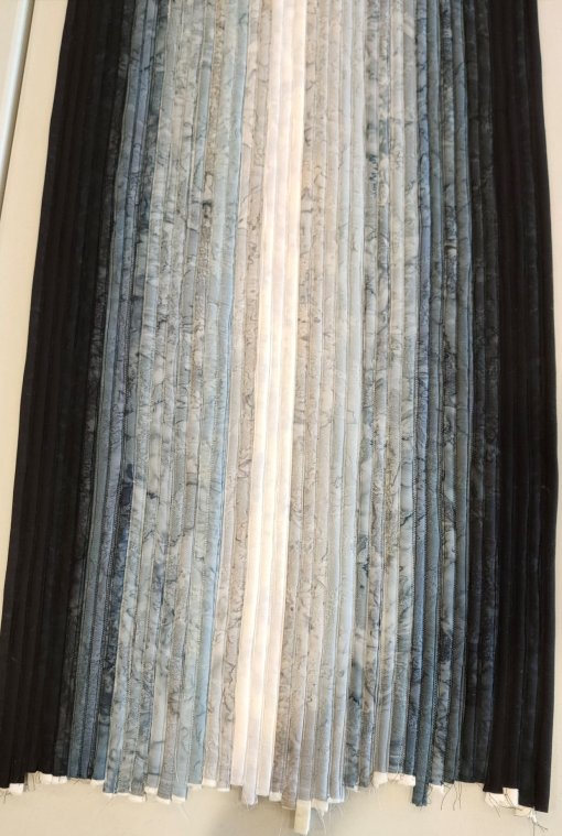 The sewn piece, ready to be made into a rug or a bag or a container, or whatever.