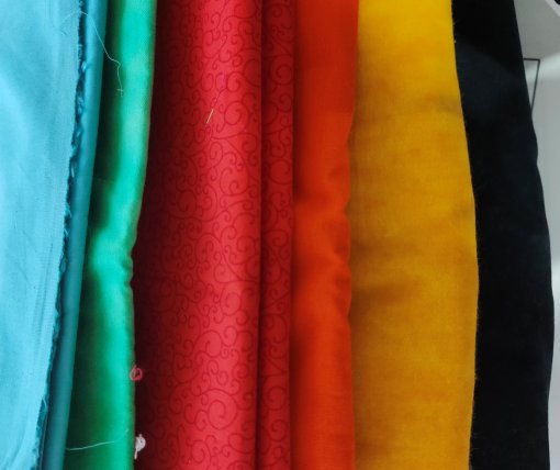 blue, green, red, orange, yellow and navy/black fabrics 